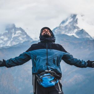 A man embraces the freedom of the mountains in Ghode Pani, Nepal.